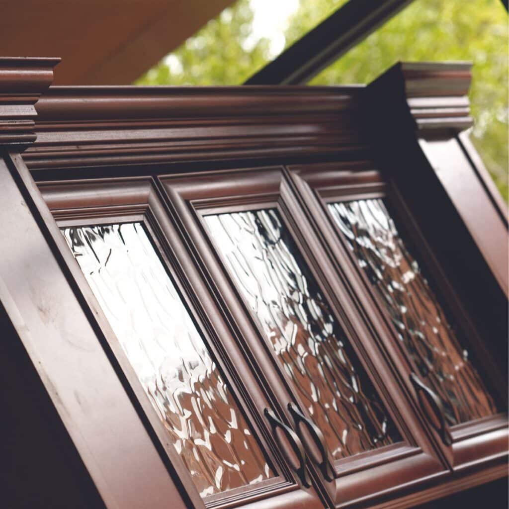 closeup of home bar cabinets with textured glass windows