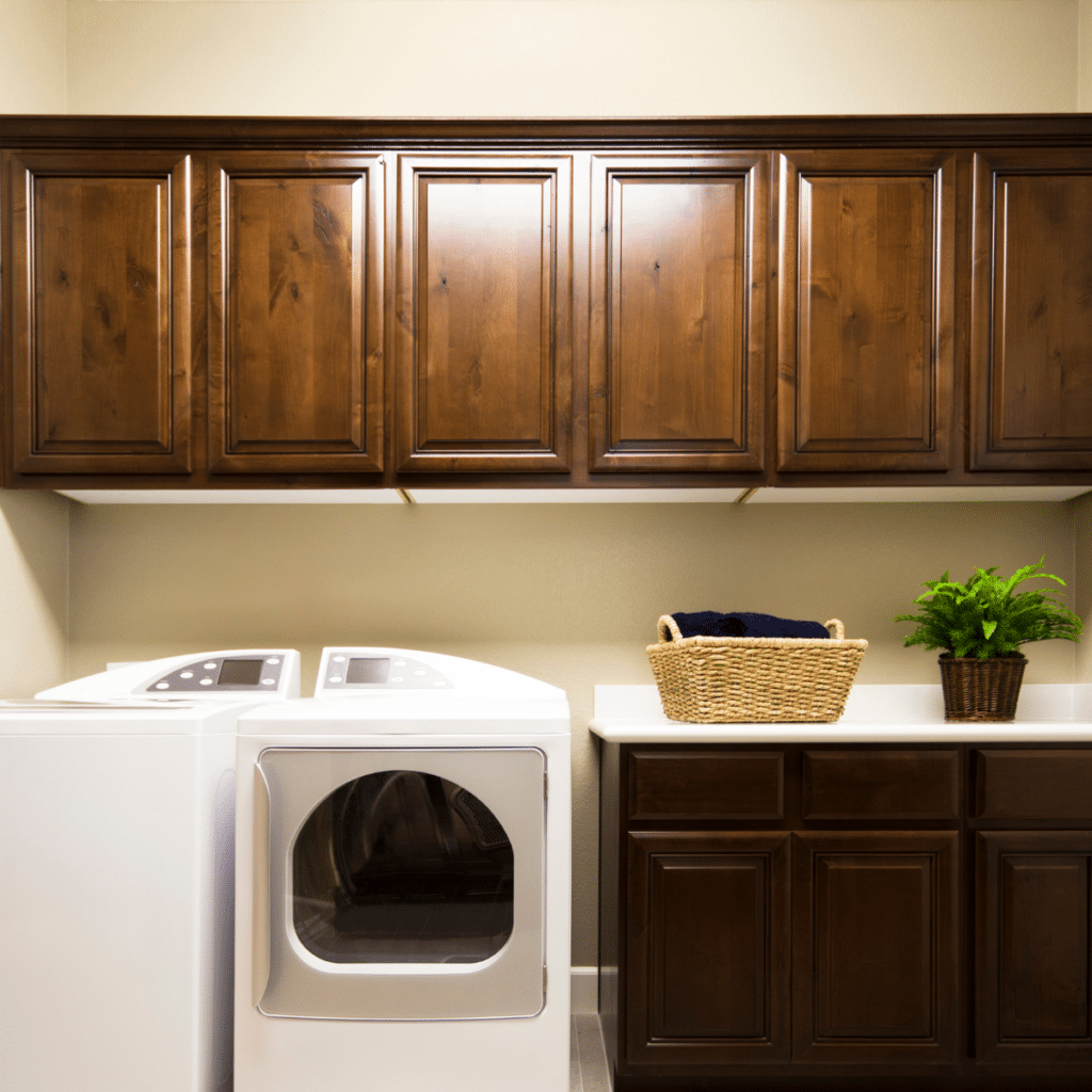 laundry room with brown cabinets and white washing machine and drying machine